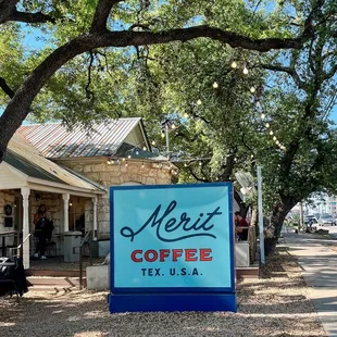 a sign in front of a building