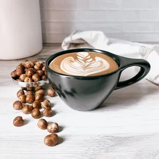 a cup of cappuccino and hazel nuts