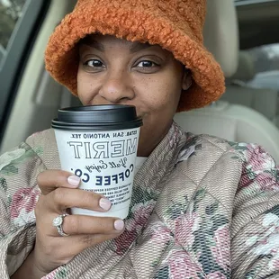 a woman holding a cup of coffee