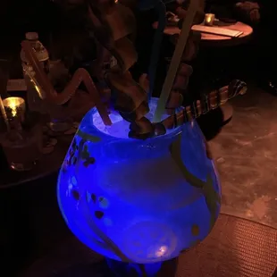 a blue vase with sticks in it