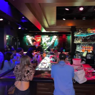 a group of people sitting at a bar