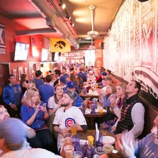 a large group of people sitting at a bar