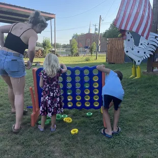 a woman and two children playing a game