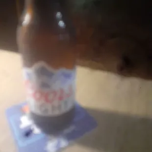 a bottle of beer on a coaster