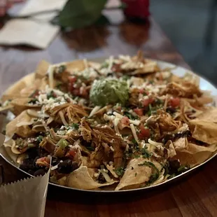 El jefe nachos with chicken-$12. Huge portion, a little cold, but absolutely delicious...and a rose from zaddy....