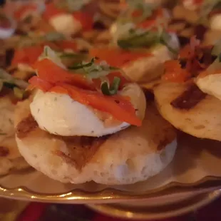Smoked Salmon with lemon dill cream cheese and shredded cucumbers on mini grilled pita rounds