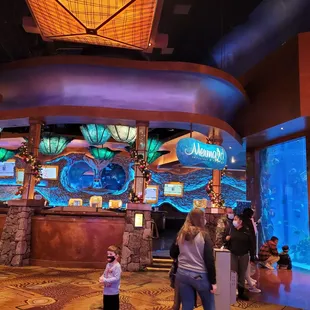 people standing in front of the aquarium