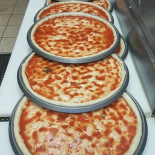 a row of pizzas