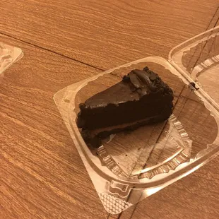 a slice of chocolate cake in a plastic container