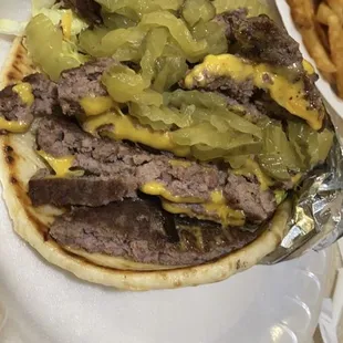Double bacon cheeseburger pita loaded with lettuce, tomatoes, pickles, onions..... thousand island on the side