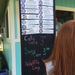 a woman looking at a menu