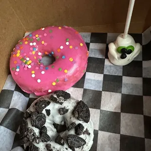 Oreo donut, strawberry sprinkled donut, a cute ghost Halloween cake pop.