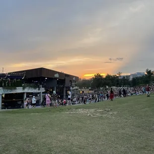 a crowd of people standing on the grass