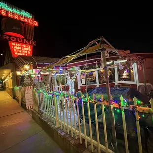 people sitting outside a restaurant at night