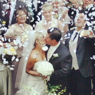 MERRY WEDDINGS : Gerry &amp; Amber kissing as their guests shower them with white rose petals. Kansas City, MO Wedding DJ &amp; Wedding MC