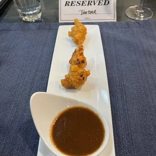 Fried Onion and potato fritters (Pakode) with spicy and sweet chutney