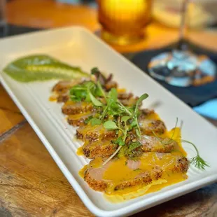 HAMACHI SASHIMI Seared yellowtail, togarashi, aji amarillo ponzu, avocado mousse citrus chimichurri, paprika oil