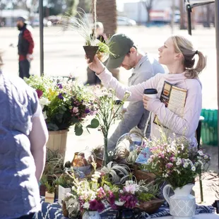 a man and a woman selecting flowers