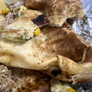 Over cooked shredded beef, quesadilla? Taste, horrible and smells horrible.