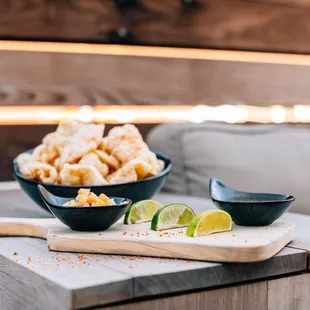 a table with a bowl of food and a bowl of dipping sauce