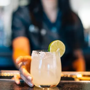 a woman holding a margarita
