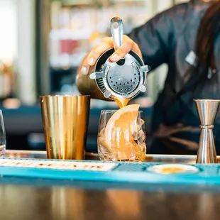 a bartender pouring a drink