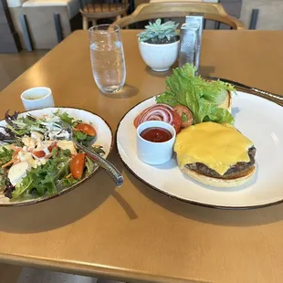 Simple cheese burger with a side salad