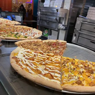 a variety of pizzas on a table