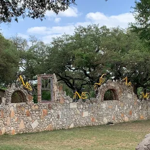a stone wall with bicycles on it