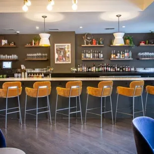 a bar with stools and shelves