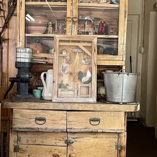 a wooden hutch with glass doors