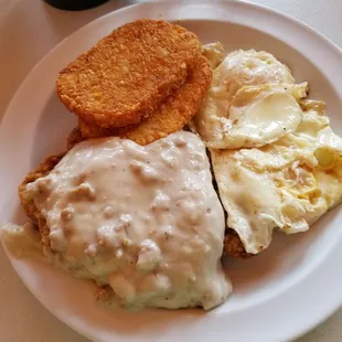 The chicken fried steak with two eggs 'over easy'and hash browns.