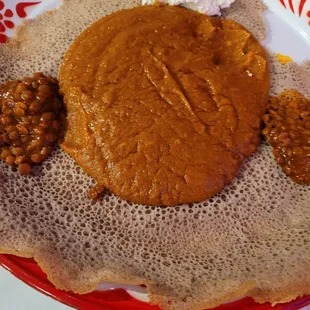 Shero (shero wot) and red lentils on cold injera breas