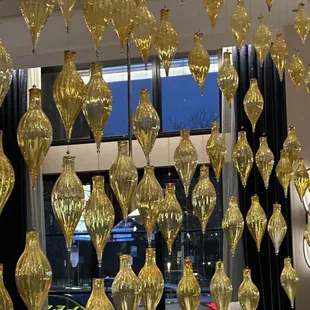 gold glass ornaments hanging from the ceiling