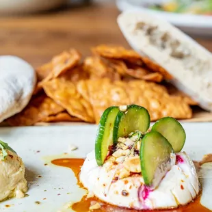 TRIO OF DIPS, hummus, smoked eggplant, red beet labneh, housemade pita bread and chips