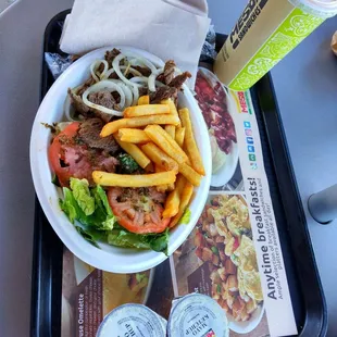 Criollo steak  puertorican style with onions and chimichrri, fries and lettuce and tomatoes