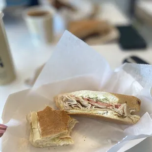 a half eaten sandwich in a basket