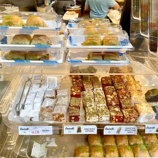 a variety of pastries in a display case