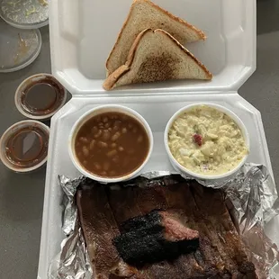 Ribs, small sample of brisket on top, baked beans and potato salad.