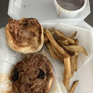 Pulled pork sandwich, fries and baked beans.