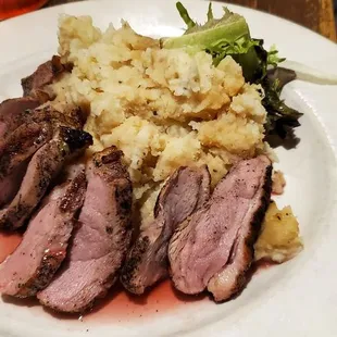 Duck in a strawberry sauce and mashed potatoes.