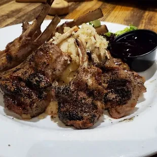 Lamb with mashed potatoes and blueberry sauce on the side.