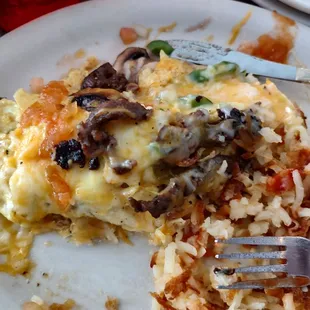 Steak omelette with hash browns.