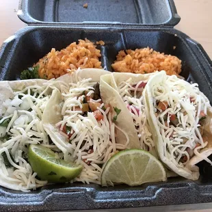 Steak and chicken tacos and rice.