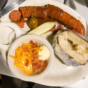 BBQ plate with sausage and loaded baked potato