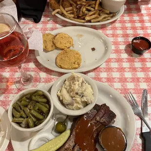 Sliced brisket, fried green tomatoes and chicken tenders all with sides and drinks.