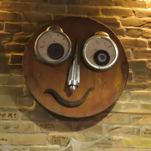 a smiley face on a brick wall