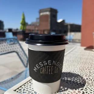 Soy latte 12 oz on the patio table