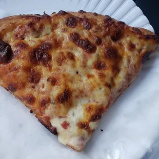 a slice of pizza on a paper plate