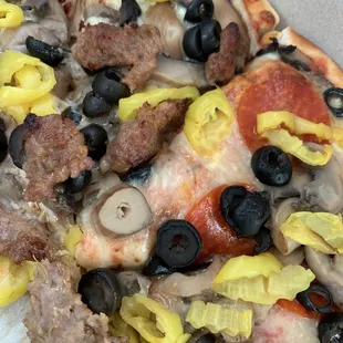 Italian sausage, pepperoni, banana peppers, mushrooms and black olives.